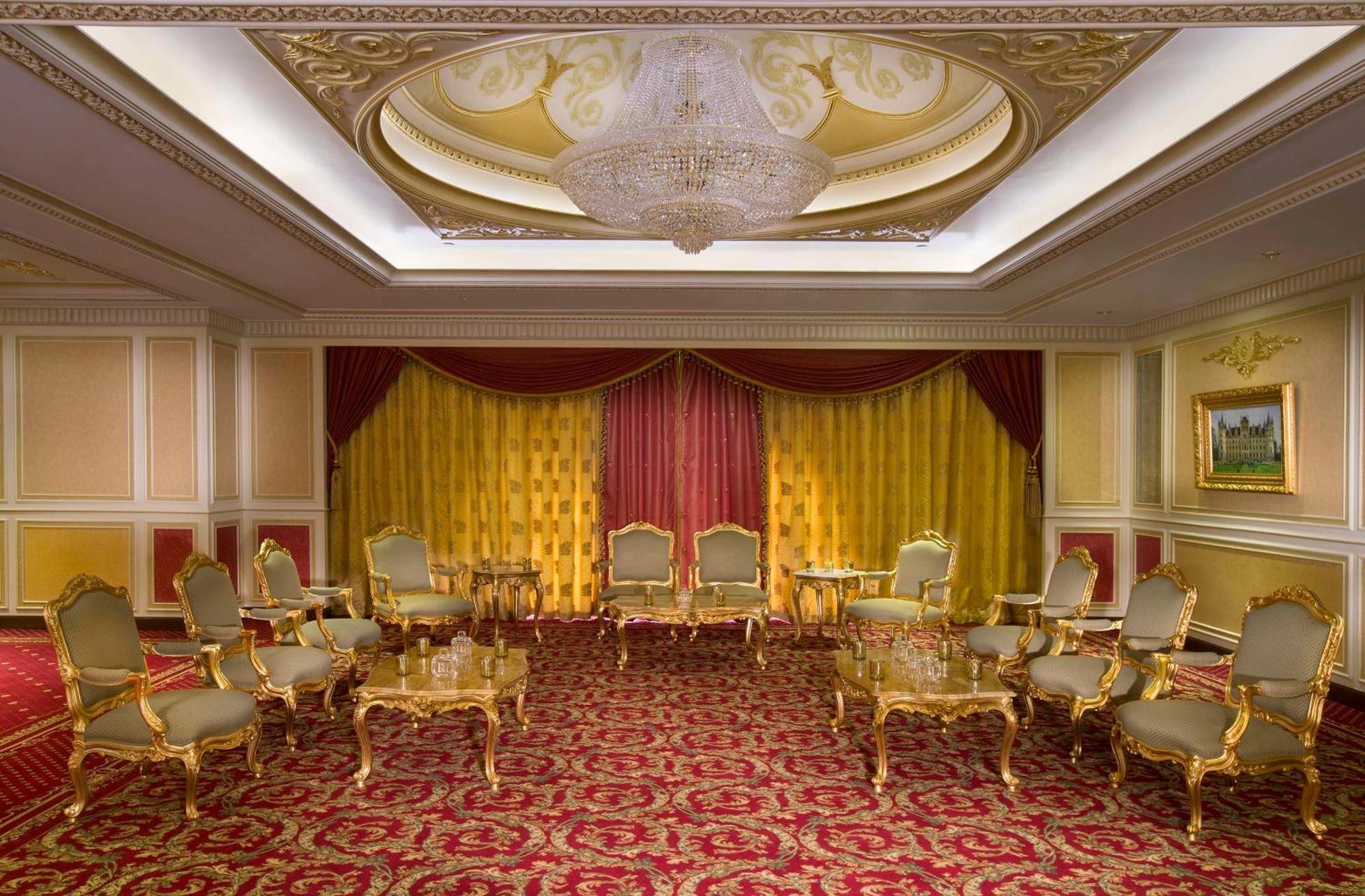 Royal Rose Abu Dhabi, A Curio Collection By Hilton Affiliated Hotel Exterior photo The photo depicts an elegantly designed room, likely a meeting or reception space. It features a luxurious interior with ornate gold accents, including richly detailed furniture such as chairs and tables. The walls have a soft color palette, and ther