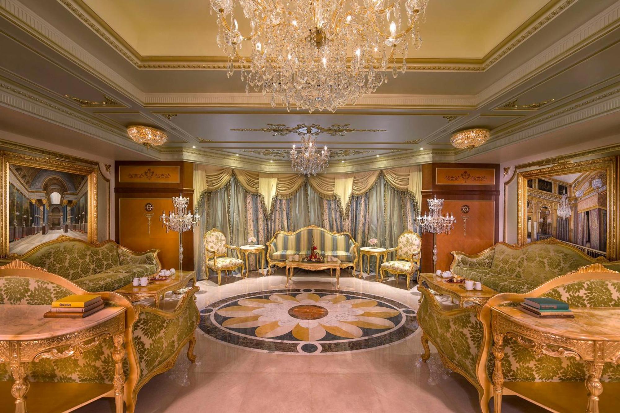 Royal Rose Abu Dhabi, A Curio Collection By Hilton Affiliated Hotel Exterior photo The photo shows a luxurious and elegantly furnished room. It features ornate furniture, including plush sofas with intricate designs and golden accents. The walls are adorned with rich drapes, and there are several decorative light fixtures, includin